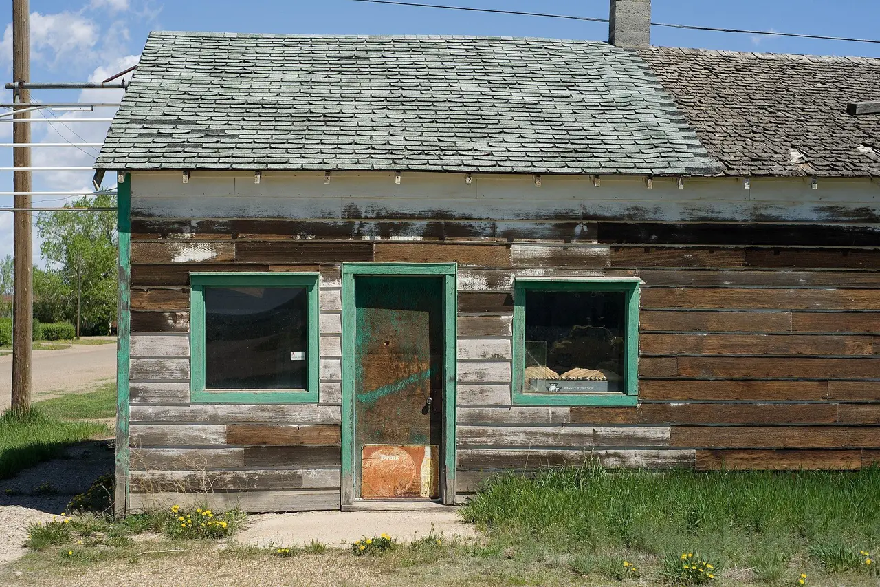 Weathered old storefront with green trim, 2009
